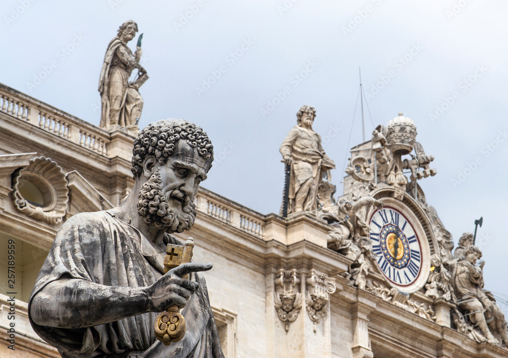 Statue of St Peter outside St Peter's basilica in Vatican City with Clock Tower on background