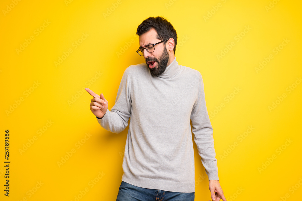 Man with beard and turtleneck enjoy dancing while listening to music at a party Man with beard and turtleneck enjoy dancing while listening to music at a party