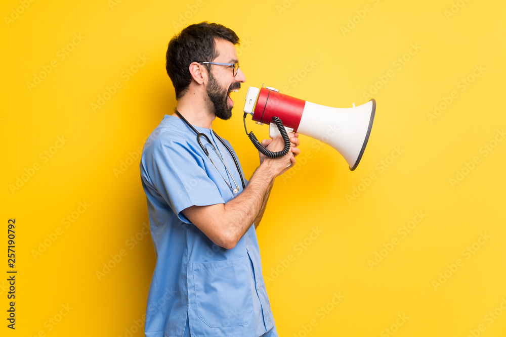 Surgeon doctor man shouting through a megaphone to announce something in lateral position Surgeon doctor man shouting through a megaphone to announce something in lateral position