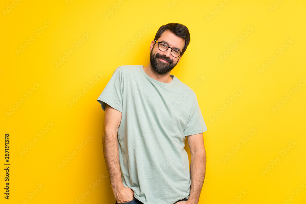 Man with beard and green shirt smiling Man with beard and green shirt smiling