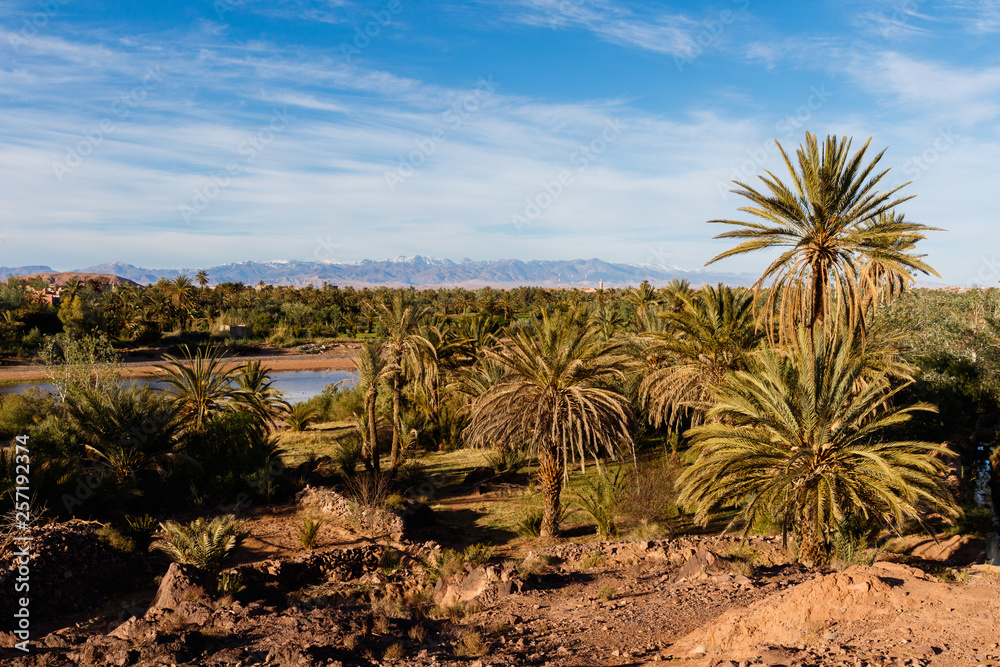 Fortified city of Ait Benhaddou along the former caravan route between the Sahara and Marrakech in Morocco with snow covered Atlas mountain range in background