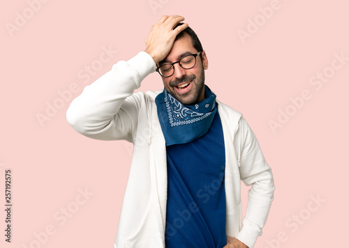 Handsome man with glasses has just realized something and has intending the solution on isolated pink background