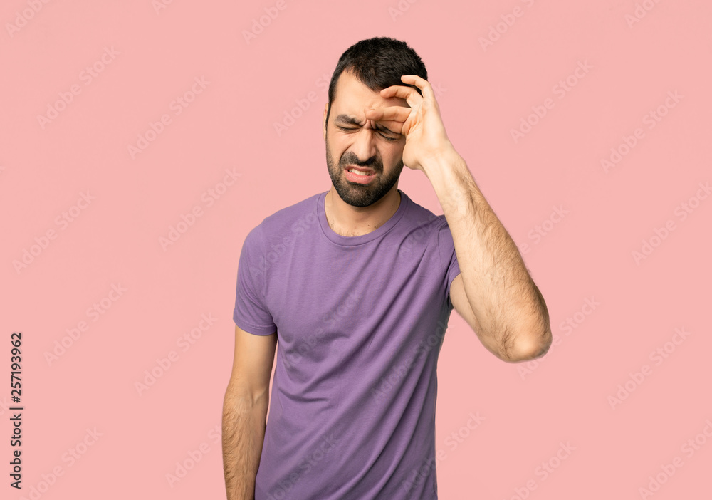 Handsome man with tired and sick expression on isolated pink background Handsome man with tired and sick expression on isolated pink background