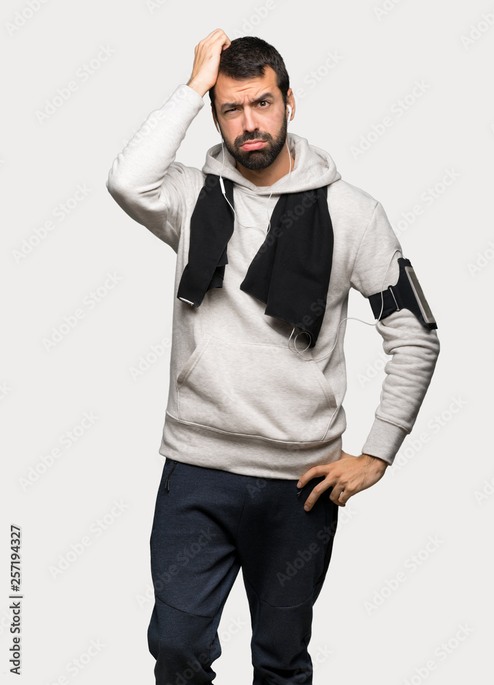 Sport man with an expression of frustration and not understanding over isolated grey background Sport man with an expression of frustration and not understanding over isolated grey background