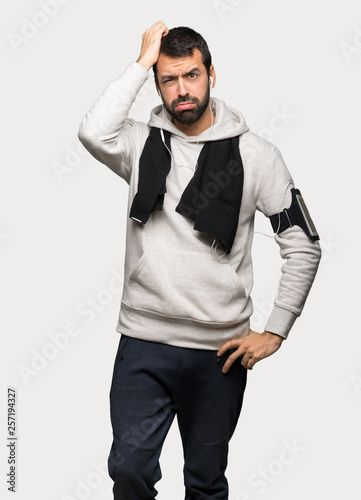 Sport man with an expression of frustration and not understanding over isolated grey background