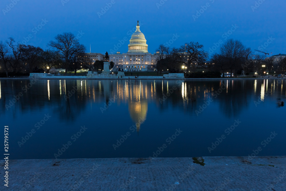 Night-time vista of the United States Capitol Building reflecting on the surface of the Capitol Reflecting Pool
