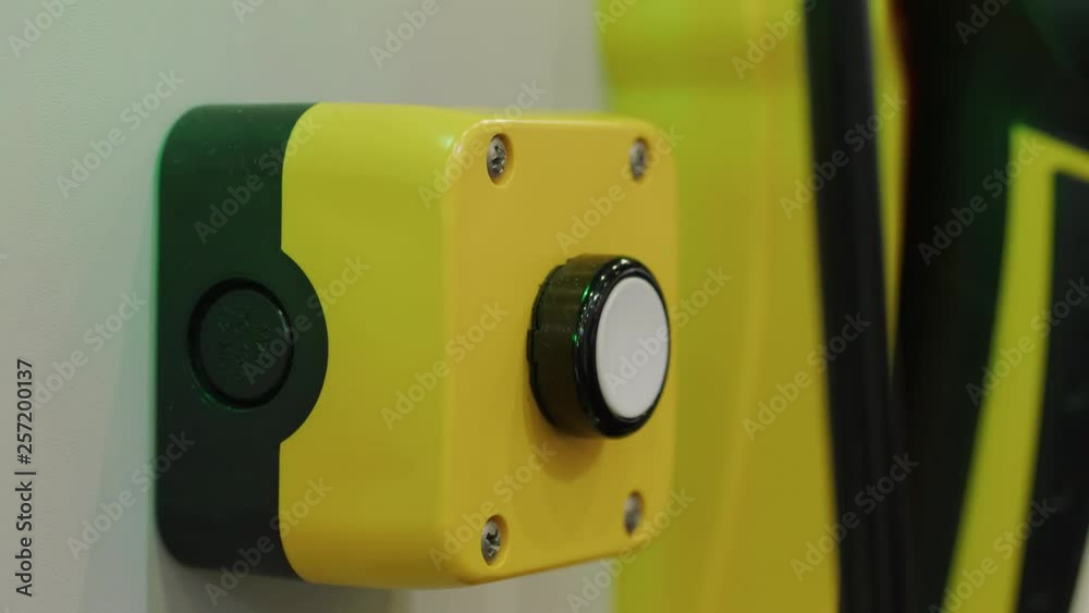 Person pressing white start button on manufacture, blinker unit