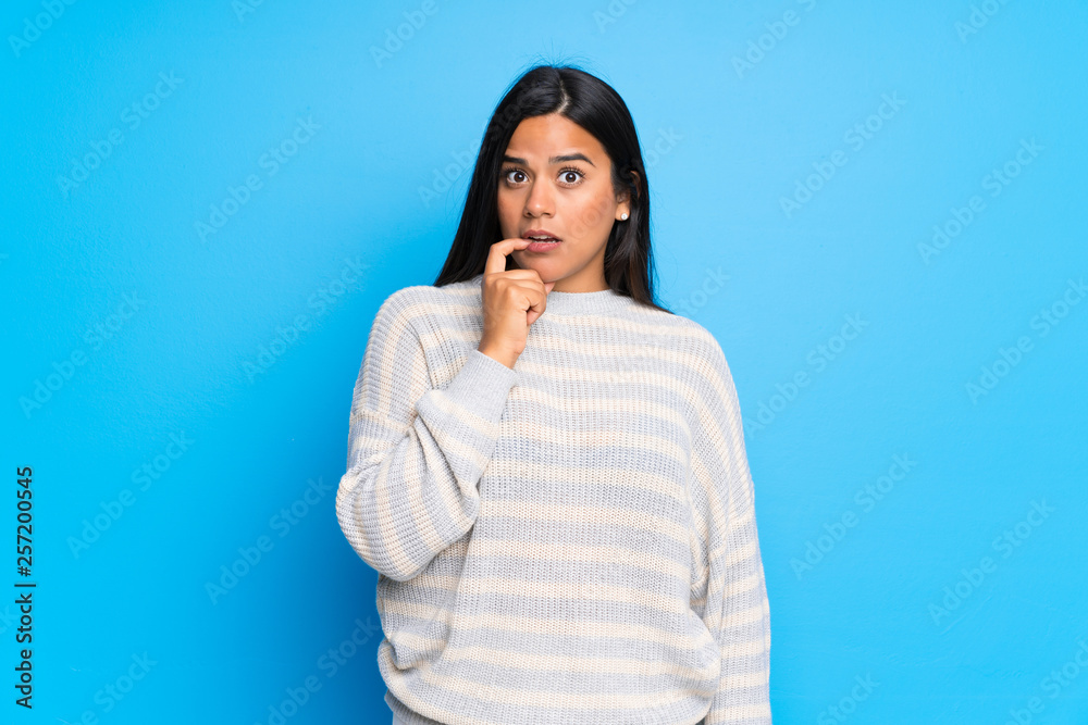 Young Colombian girl with sweater having doubts while looking up Young Colombian girl with sweater having doubts while looking up
