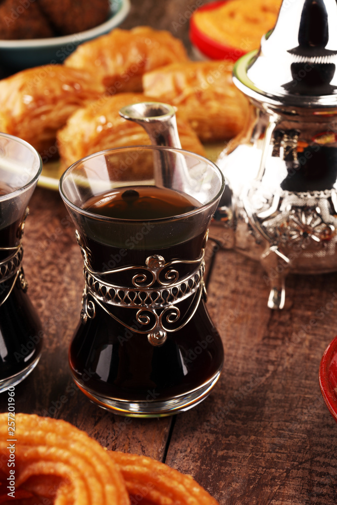 Obraz premium Middle eastern or arabic dishes and assorted meze, concrete rustic background. Turkish Bread or Turkish pizza. Dessert Baklava with pistachio. falafel with hommos. Halal food. Lebanese cuisine