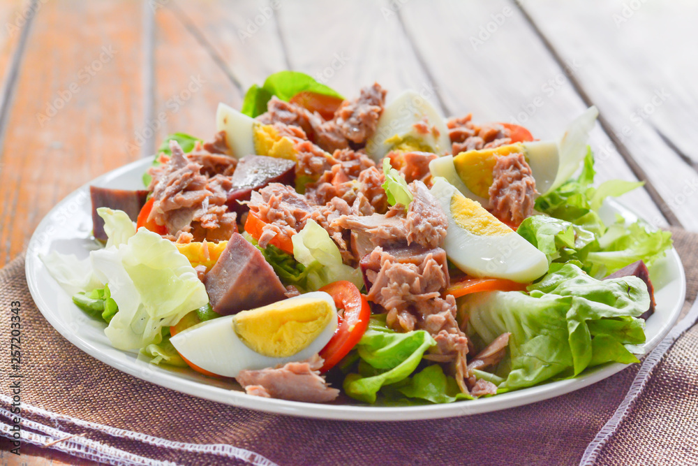 tuna salad with boiled egg, tomato slice, sweet potato and lettuce on white dish. Healthy food for loose weight, high fiber and low fat. tuna salad with boiled egg, tomato slice, sweet potato and lettuce on white dish. Healthy food for loose weight, high fiber and low fat.