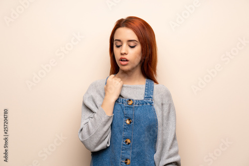 Young redhead woman over isolated background with tired and sick expression © luismolinero