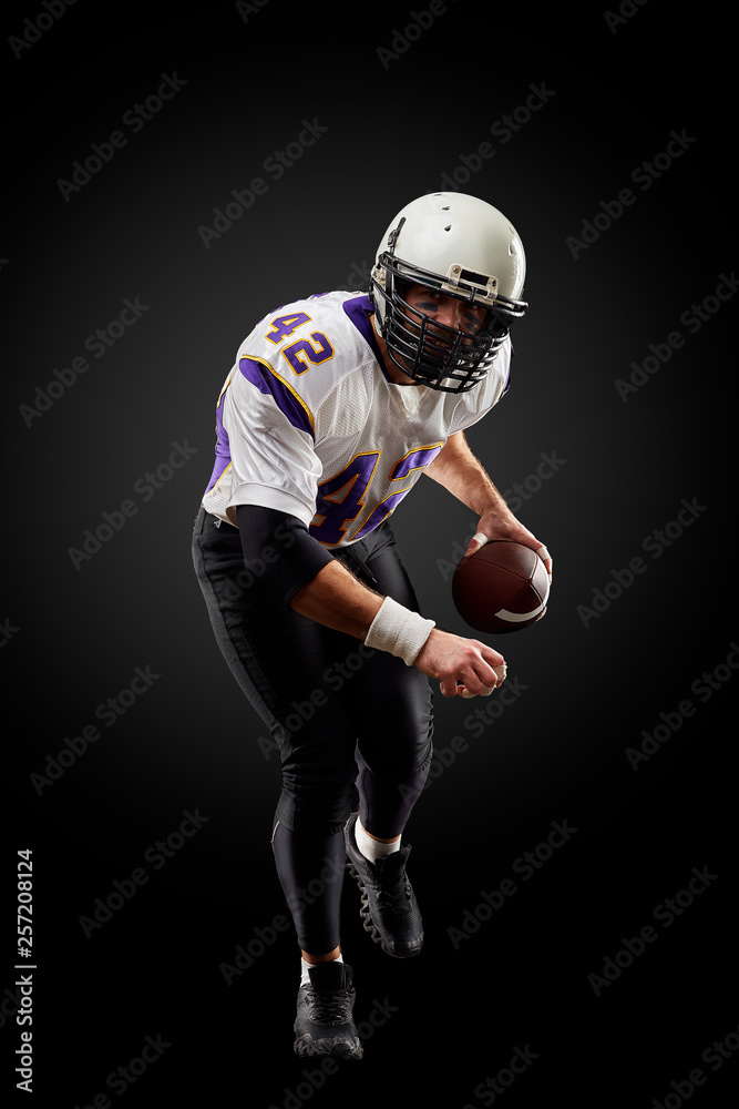 American football sportsman player on black background. Sport concept.