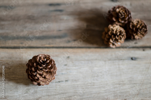 pine cones on wood background 