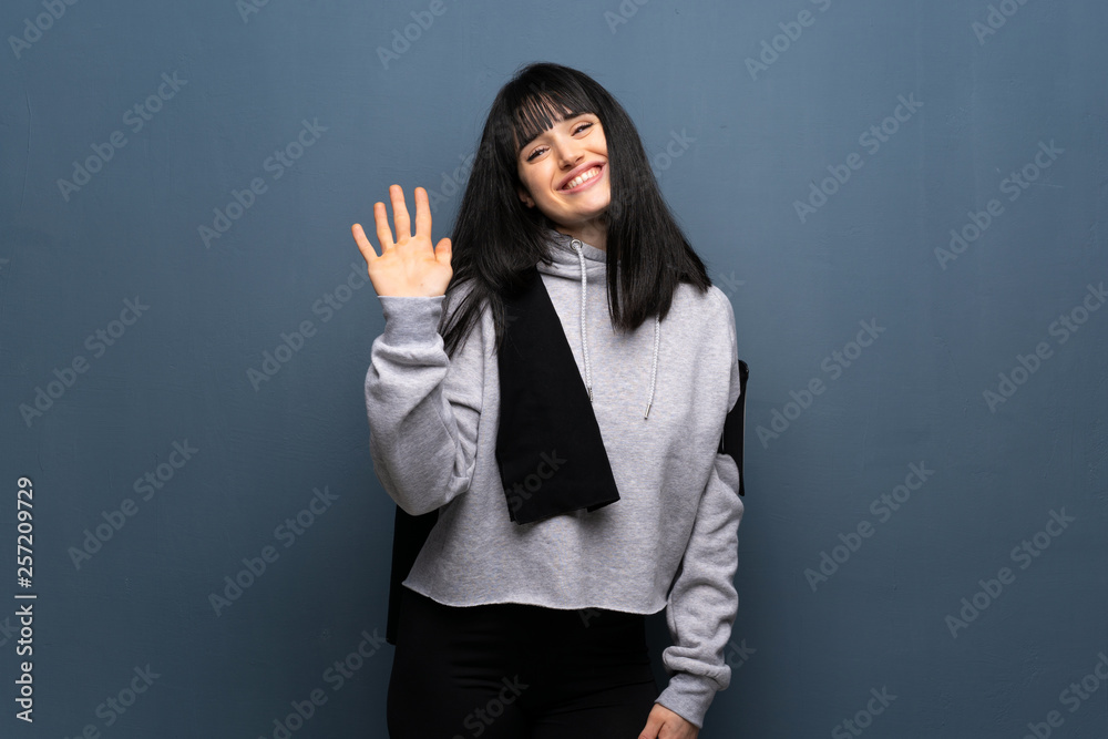 Young sport woman saluting with hand with happy expression Young sport woman saluting with hand with happy expression