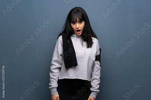 Young sport woman with surprise facial expression