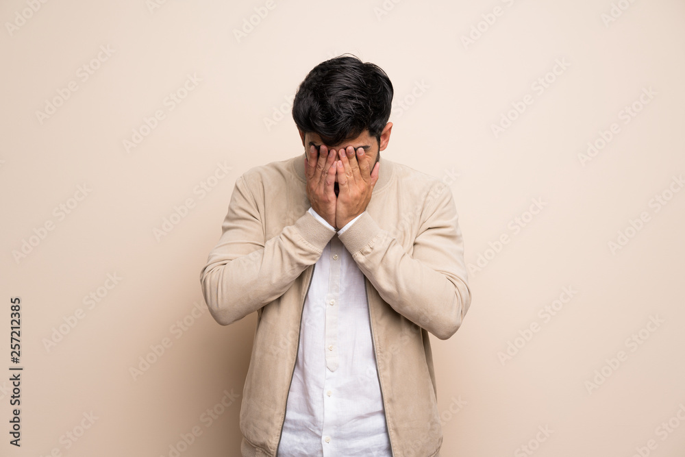 Young man over isolated wall with tired and sick expression Young man over isolated wall with tired and sick expression