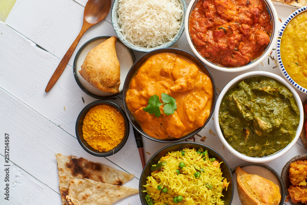 Assorted Indian various food with spices, rice and fresh vegetables Assorted Indian various food with spices, rice and fresh vegetables