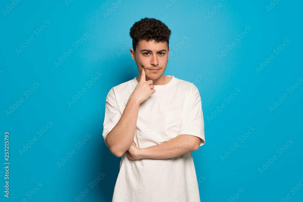 Young man over blue background thinking Young man over blue background thinking
