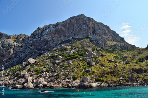 Sea bay with turquoise water, beach and mountains, Cala Figuera on Cap Formentor