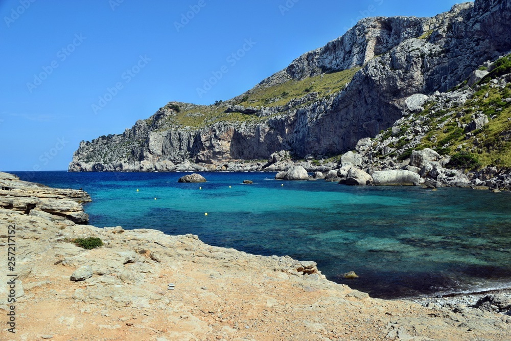 Sea bay with turquoise water, beach and mountains, Cala Figuera on Cap Formentor