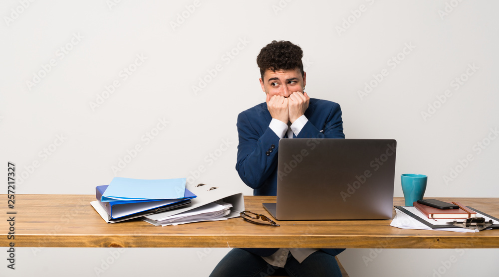 Business man in a office nervous and scared putting hands to mouth Business man in a office nervous and scared putting hands to mouth