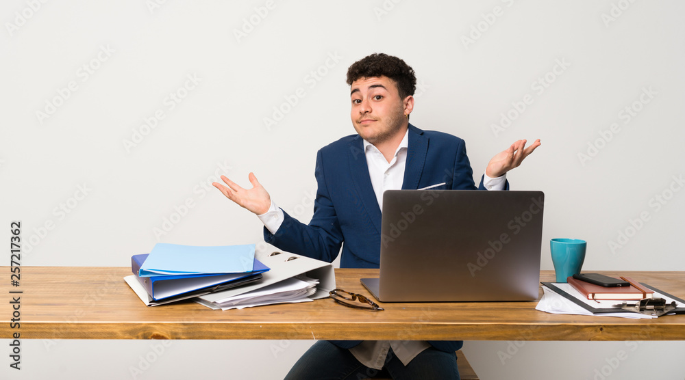 Business man in a office making doubts gesture Business man in a office making doubts gesture