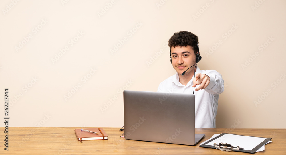 Telemarketer man points finger at you with a confident expression Telemarketer man points finger at you with a confident expression