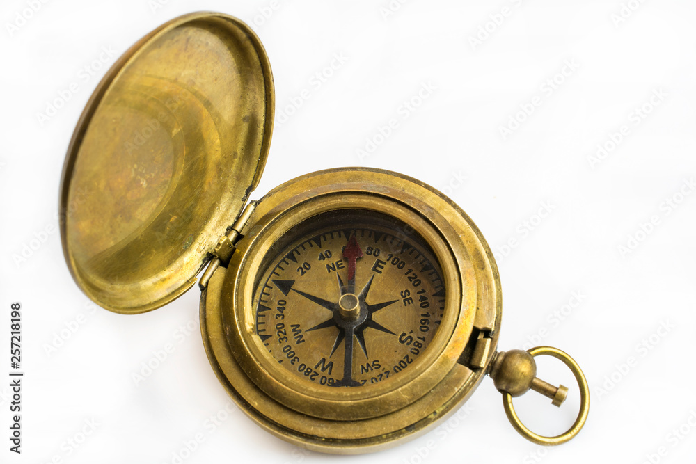 Bronze compass close-up isolated on a white background. Bronze compass close-up isolated on a white background.