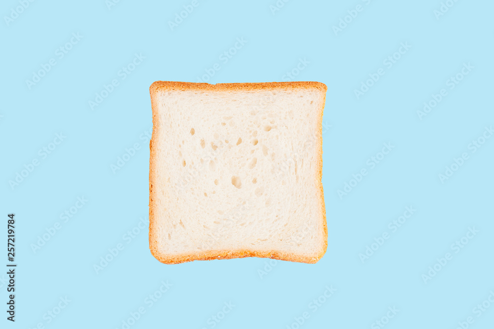Single slice of toast bread isolated on blue background