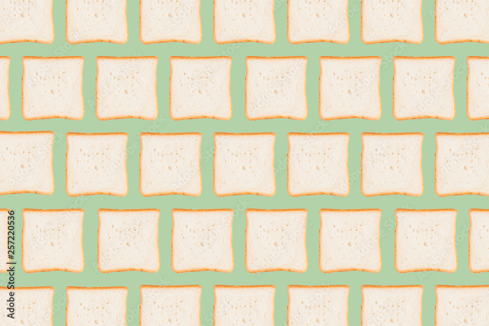 Sliced toast bread isolated on green background
