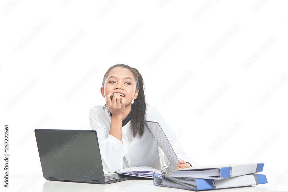 Office lady in white shirt and ponytail hair using a laptop and file Office lady in white shirt and ponytail hair using a laptop and file