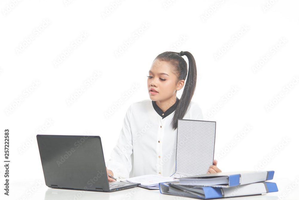 Office lady in white shirt and ponytail hair using a laptop and file Office lady in white shirt and ponytail hair using a laptop and file
