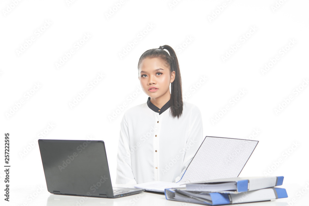 Office lady in white shirt and ponytail hair using a laptop and file Office lady in white shirt and ponytail hair using a laptop and file