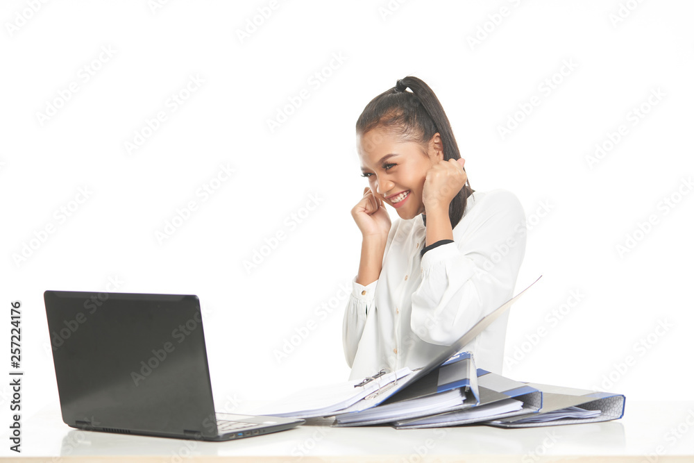 Office lady in white shirt and ponytail hair using a laptop and file Office lady in white shirt and ponytail hair using a laptop and file