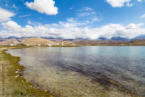 Fototapeta Naklejka Na Ścianę i Meble -  Karakul Lake along Karakorum Highway, Xinjiang, China, connecting Kashgar and the Pakistan border. 3600m, it is the highest lake in Pamir Plateau. Mt. Kongur, 7700m, is visible in the background