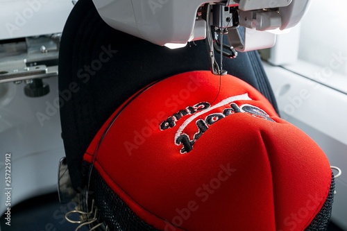 Embroidered cap and embroidery machine close up image photo