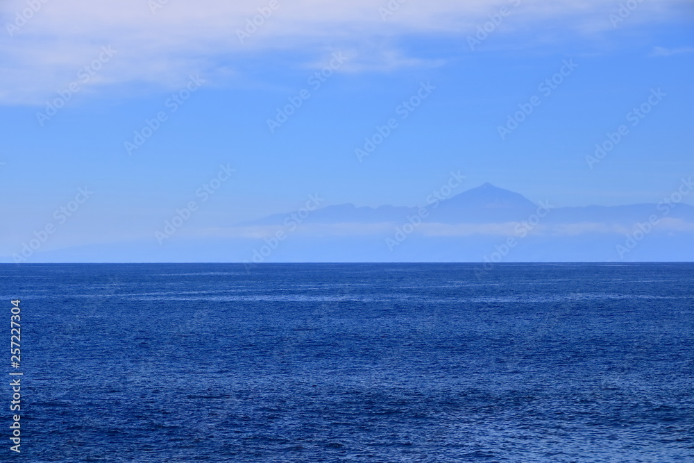 View of Tenerife island with the volcano Teide with the Atlantic Ocean in between View of Tenerife island with the volcano Teide with the Atlantic Ocean in between