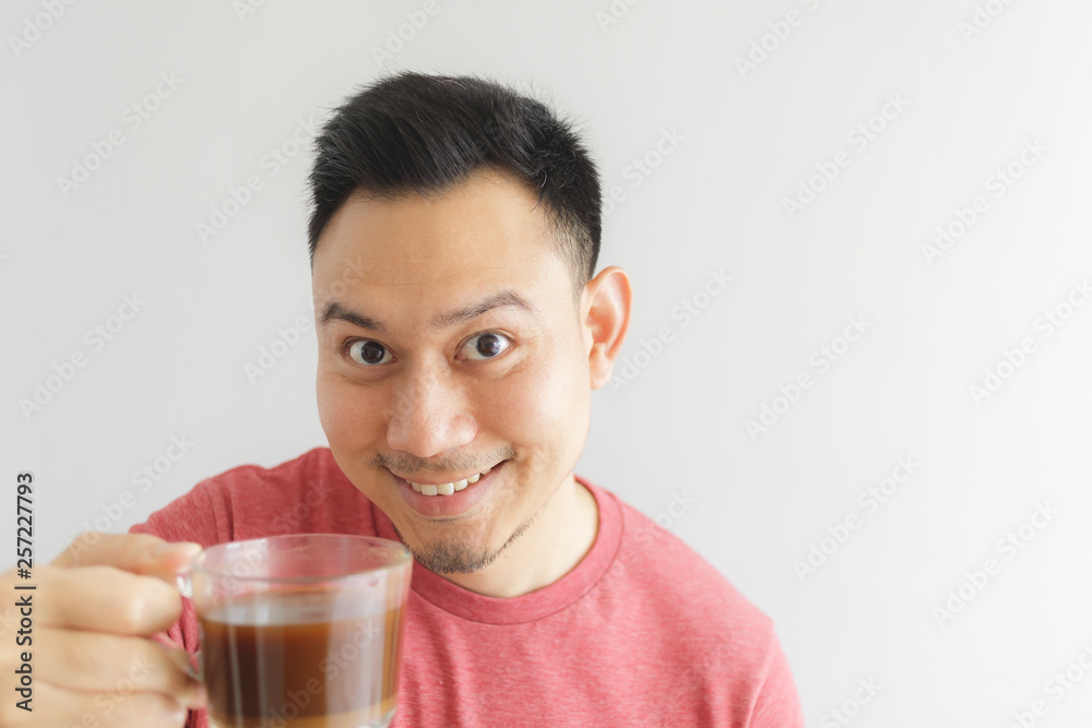 Healthy Asian man offer herbal drink in a glass cup. Healthy Asian man offer herbal drink in a glass cup.