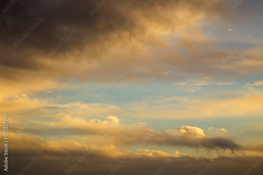 Bright blue sky with gentle cumulus clouds. Pink vanilla heaven. Natural summer and spring background.