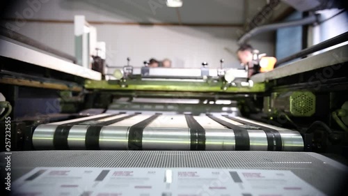 Large Industrial Printer Stands Near A Drying Conveyor