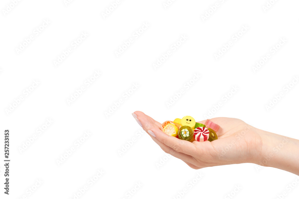 Hand with colored round candy, sugar lollipop Hand with colored round candy, sugar lollipop