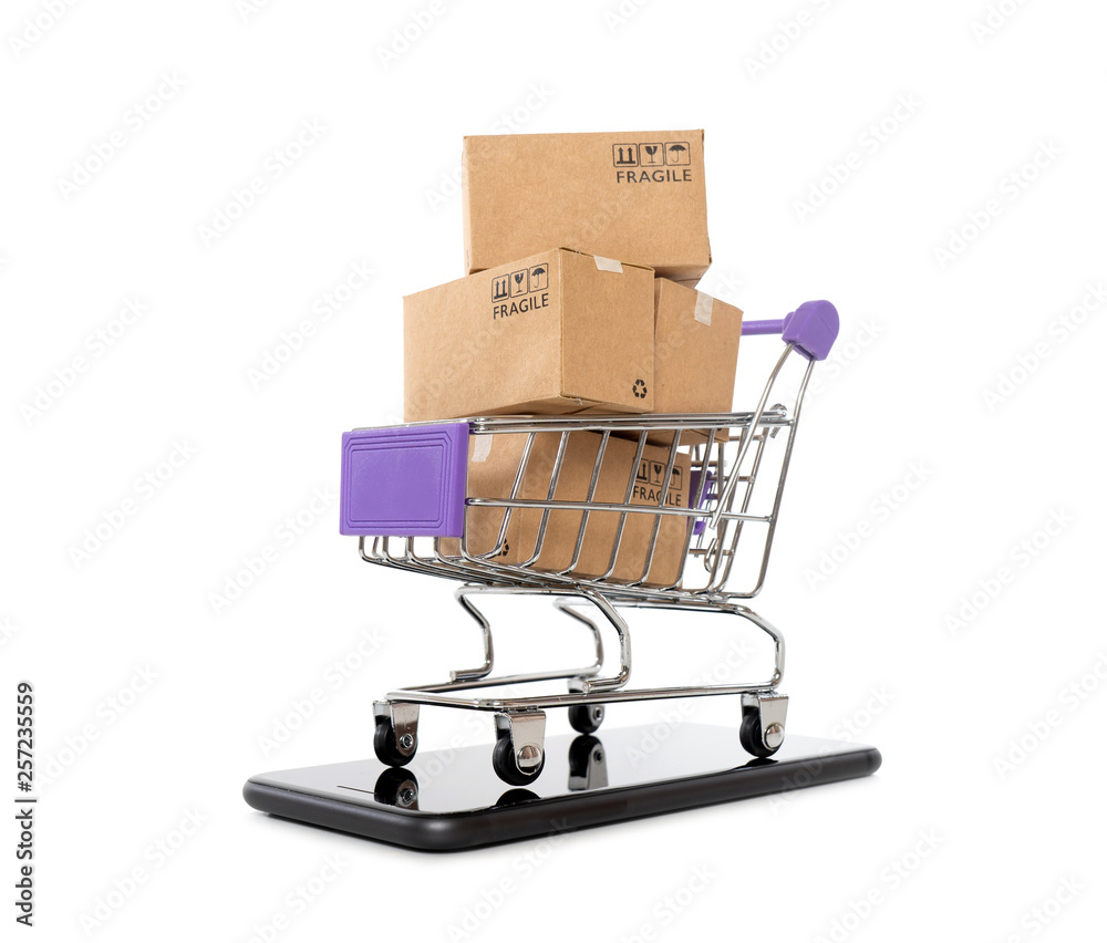 Paper boxes in a trolley with mobile phone on white background,Online shopping or ecommmerce concept
