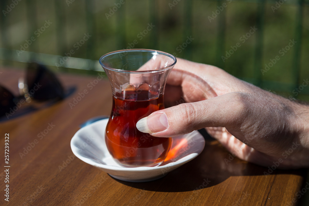 the man hold glass of tea in the hand. the man hold glass of tea in the hand.