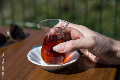 the man hold glass of tea in the hand.