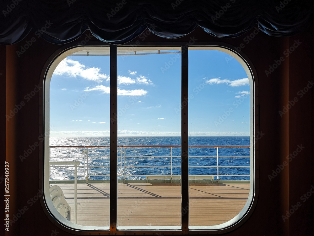 A view from the window of a cruise ship, showing the clear sky ocean.
