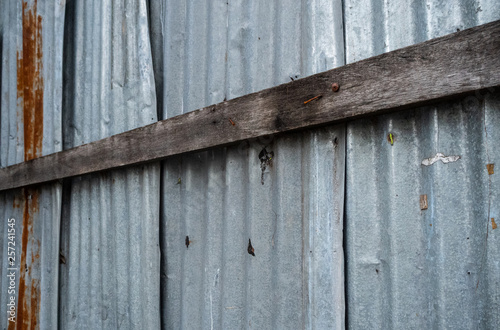 Wooden planks on the corrugated galvanized sheet, abstract, wallpaper