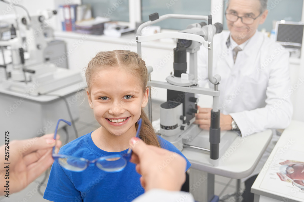 Girl on consultation with optometrist, choosing glasses. Girl on consultation with optometrist, choosing glasses.