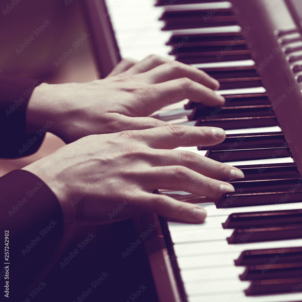 Hands of a musician playing a synthesizer closeup Hands of a musician playing a synthesizer closeup