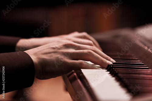  Hands of a musician playing a synthesizer closeup