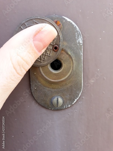 door peephole on the iron door brown